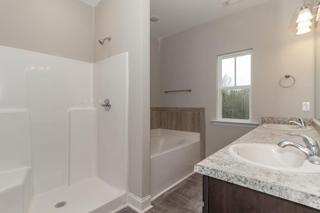 bathroom with shower with separate bathtub and vanity