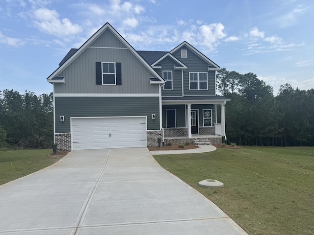 craftsman-style home featuring driveway, covered porch, an attached garage, a front yard, and brick siding