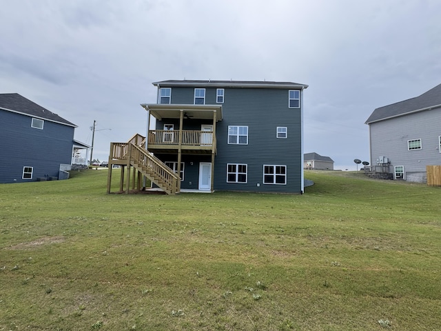 rear view of property with a lawn, a wooden deck, and stairway