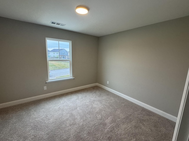carpeted empty room with baseboards and visible vents