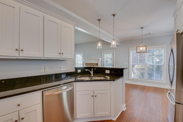 524 Jutland Way, Evans, GA 30809 - kitchen with appliances with stainless steel finishes, white cabinets, wood-type flooring, decorative light fixtures, and crown molding