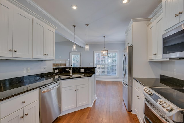 524 Jutland Way, Evans, GA 30809 - kitchen with stainless steel appliances, ornamental molding, white cabinets, recessed lighting, and decorative light fixtures