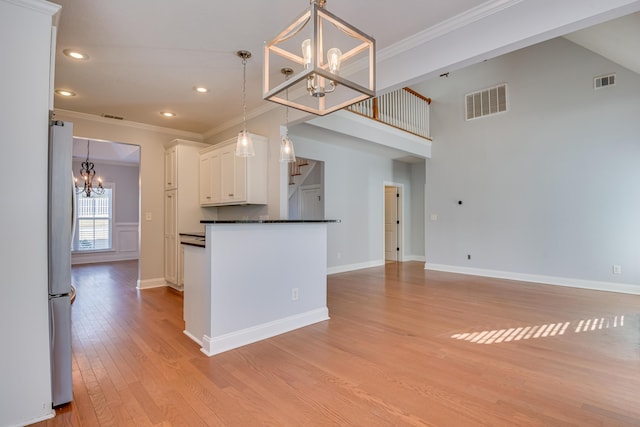 524 Jutland Way, Evans, GA 30809 - kitchen featuring a chandelier, freestanding refrigerator, dark countertops, ornamental molding, and white cabinets