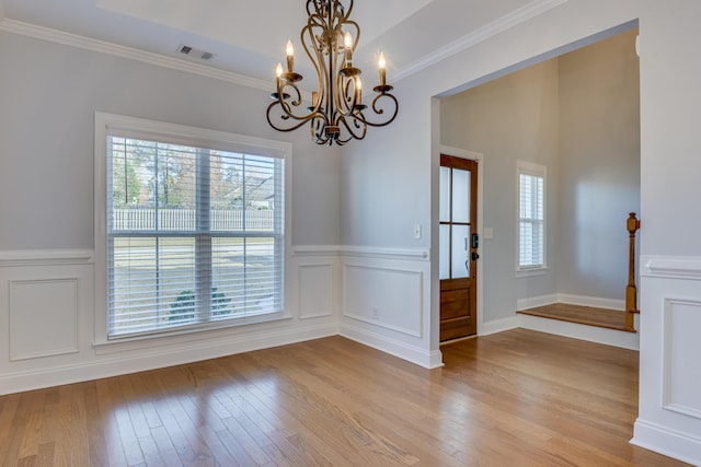 524 Jutland Way, Evans, GA 30809 - unfurnished room with a chandelier, hardwood / wood-style flooring, wainscoting, crown molding, and a decorative wall