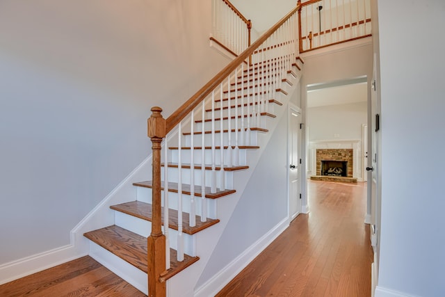 524 Jutland Way, Evans, GA 30809 - staircase featuring wood-type flooring, a fireplace, and a high ceiling