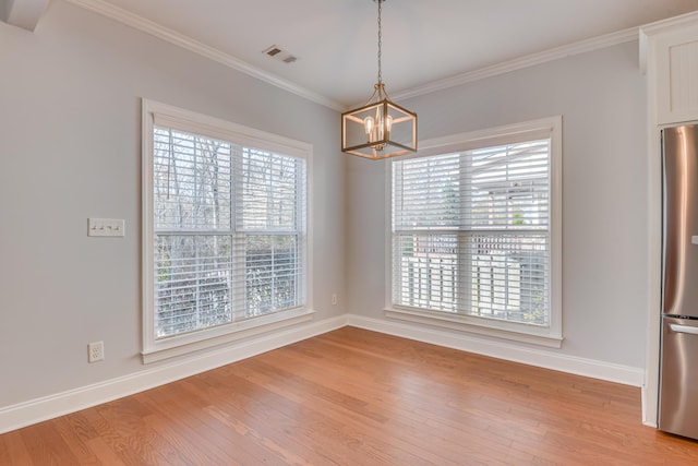 524 Jutland Way, Evans, GA 30809 - unfurnished dining area with a chandelier, light wood-style flooring, and crown molding