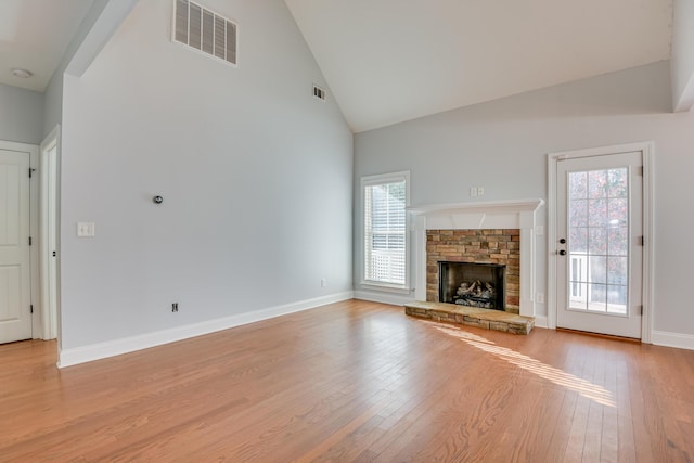 524 Jutland Way, Evans, GA 30809 - unfurnished living room with high vaulted ceiling, light wood-style floors, healthy amount of natural light, and a stone fireplace
