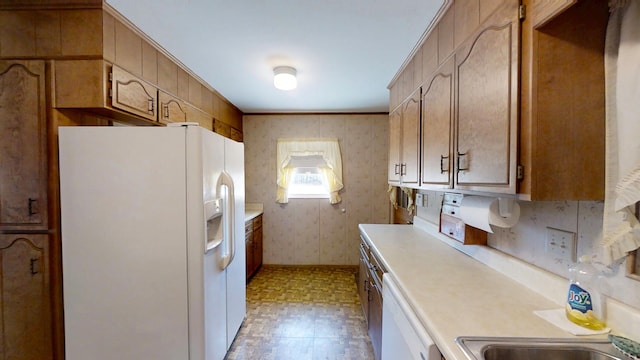 kitchen featuring white appliances, brown cabinetry, light floors, wallpapered walls, and light countertops