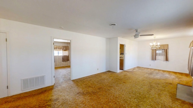 unfurnished room with visible vents, ceiling fan with notable chandelier, and carpet