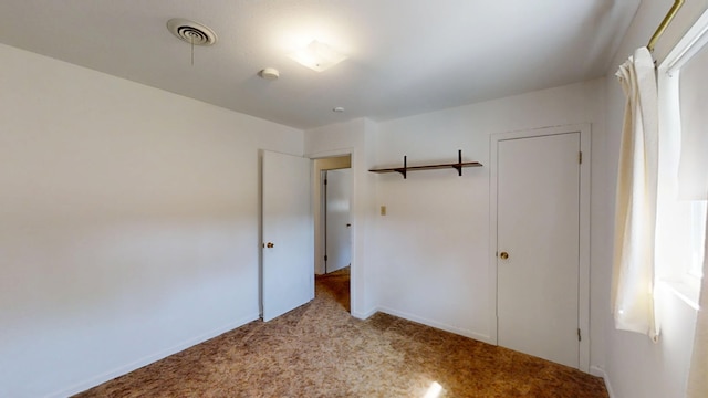 unfurnished bedroom with visible vents and carpet flooring