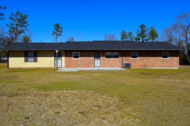 ranch-style home featuring brick siding, central air condition unit, a patio area, and a front yard