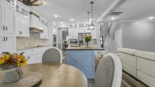 2628 Laurens St, Grovetown, GA 30813 - kitchen with custom exhaust hood, crown molding, a sink, stainless steel appliances, and dark wood-type flooring