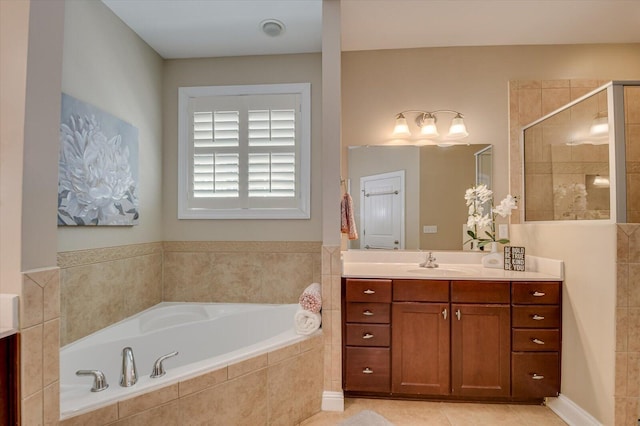 bathroom with vanity, a bath, a stall shower, and tile patterned flooring