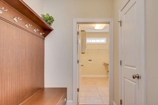 mudroom with light tile patterned floors and baseboards