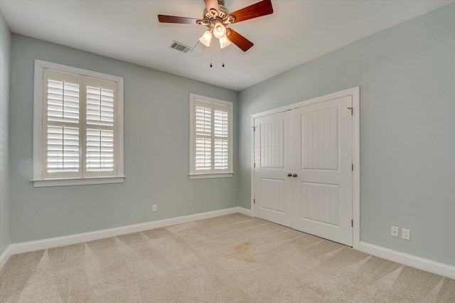 unfurnished bedroom featuring a closet, visible vents, baseboards, and carpet floors