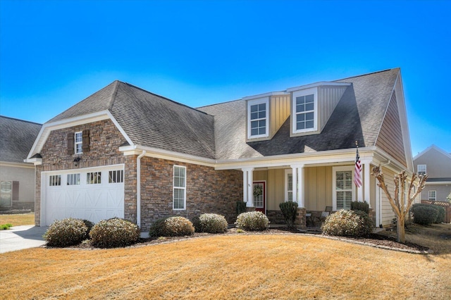 view of front facade featuring driveway, stone siding, covered porch, a front yard, and a garage