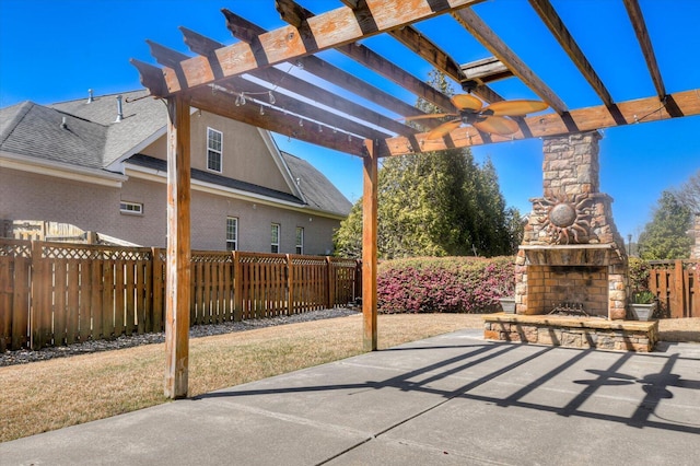 view of patio / terrace featuring an outdoor stone fireplace, a pergola, and fence