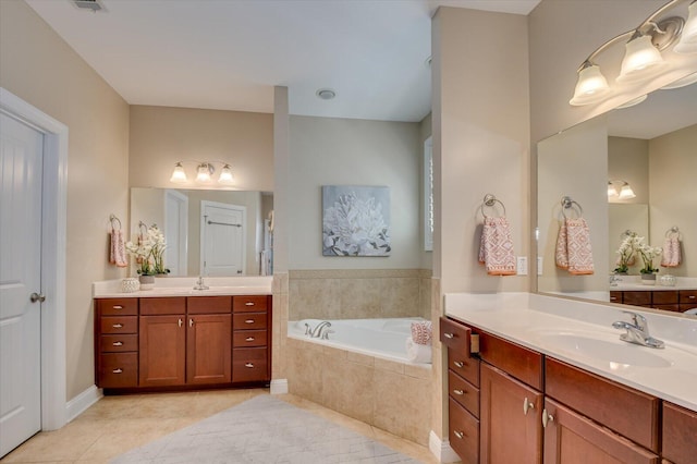 full bathroom with a sink, two vanities, a bath, and tile patterned flooring