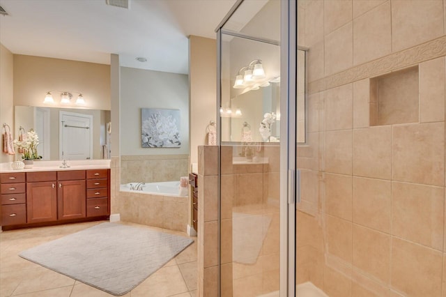 full bathroom with a stall shower, vanity, a bath, and tile patterned floors