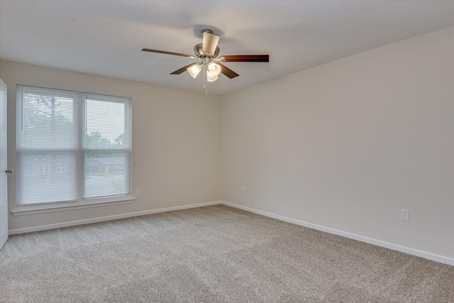 unfurnished room featuring carpet floors and baseboards