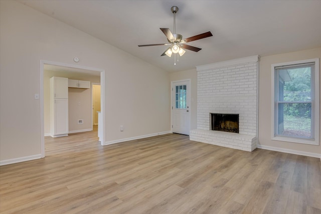 unfurnished living room featuring ceiling fan, vaulted ceiling, healthy amount of natural light, light wood-type flooring, and baseboards