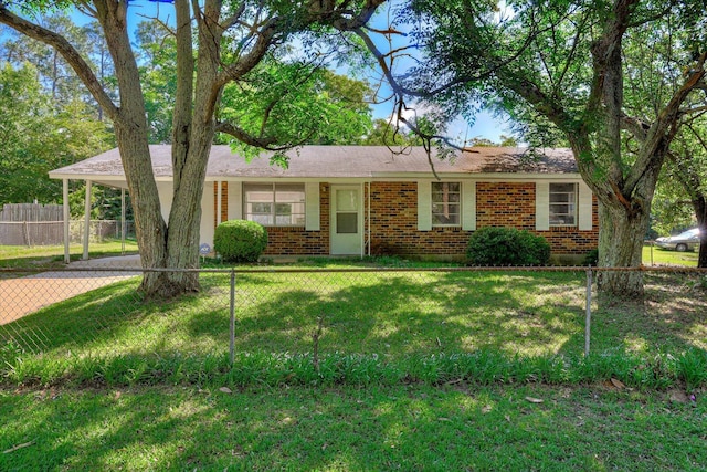 ranch-style home featuring a front yard and a carport