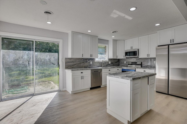 kitchen featuring white cabinets, appliances with stainless steel finishes, and sink