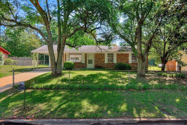 ranch-style home featuring a front lawn and a carport