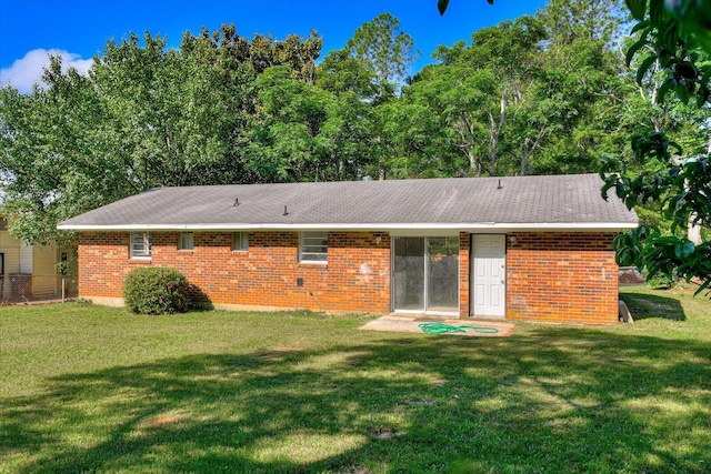 back of house featuring a yard