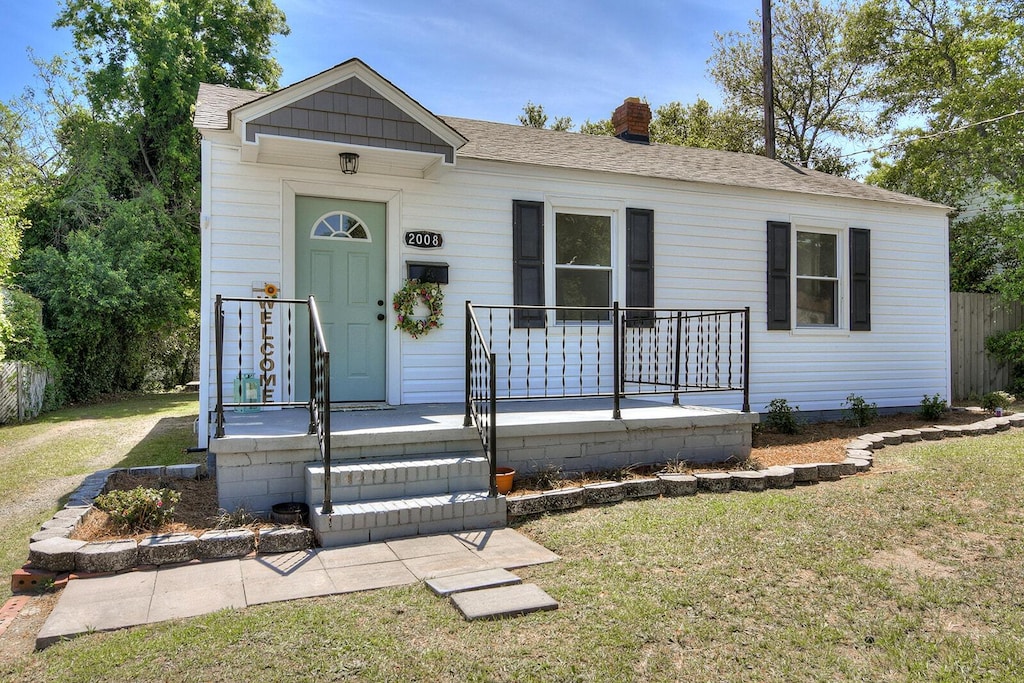 2008 Richmond Ave, Augusta, GA 30904 - view of front facade with a shingled roof, a chimney, and a front yard