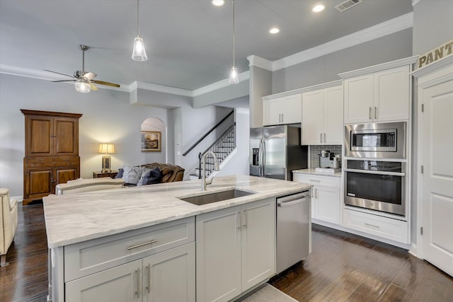 1856 Preservation Cir, Evans, GA 30809 - kitchen featuring stainless steel appliances, open floor plan, crown molding, white cabinetry, and a ceiling fan