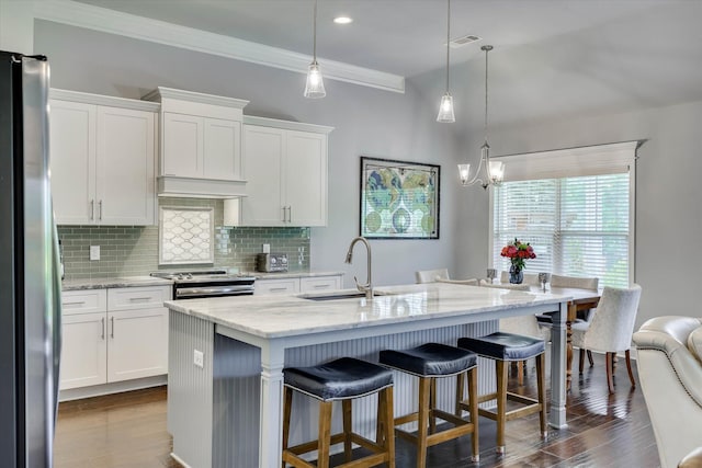 1856 Preservation Cir, Evans, GA 30809 - kitchen featuring appliances with stainless steel finishes, decorative backsplash, dark wood finished floors, white cabinetry, and crown molding
