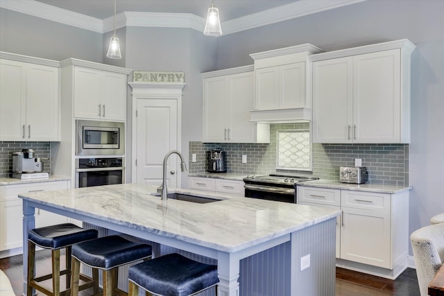 1856 Preservation Cir, Evans, GA 30809 - kitchen with stainless steel appliances, tasteful backsplash, crown molding, white cabinetry, and a kitchen breakfast bar