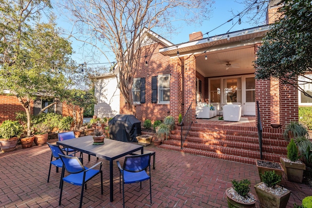 view of patio / terrace with a ceiling fan, outdoor dining space, and a grill