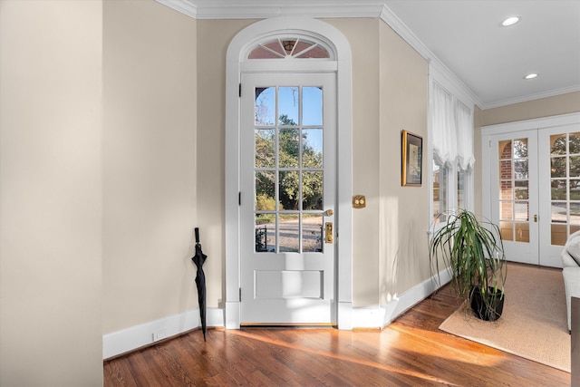 entrance foyer featuring baseboards, wood finished floors, crown molding, and french doors