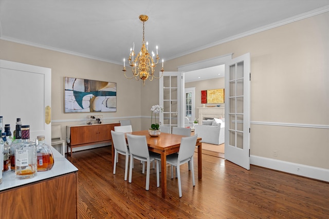 dining area featuring a fireplace, baseboards, french doors, dark wood-style floors, and crown molding