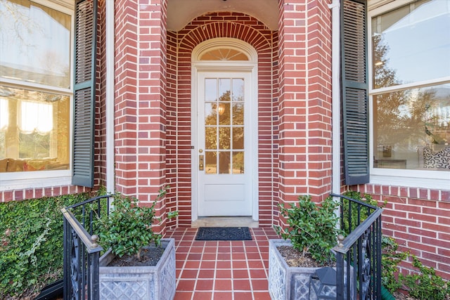 doorway to property featuring brick siding