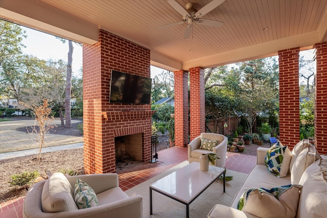 view of patio with an outdoor living space with a fireplace, fence, and a ceiling fan