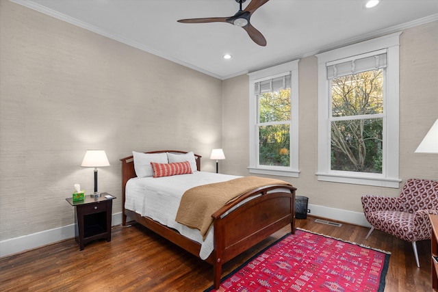 bedroom featuring visible vents, crown molding, baseboards, and wood finished floors