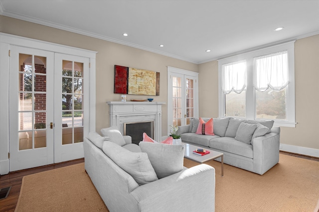 living area with visible vents, ornamental molding, wood finished floors, french doors, and recessed lighting