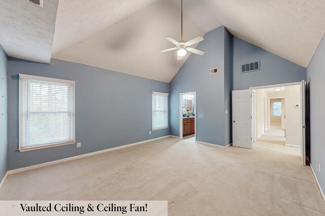 unfurnished bedroom with high vaulted ceiling, light carpet, a textured ceiling, and ceiling fan