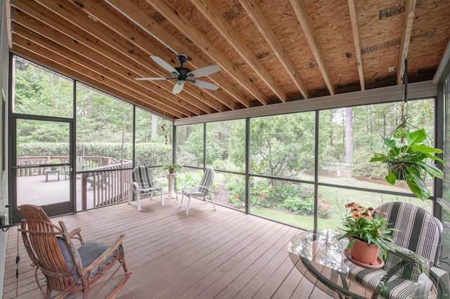 unfurnished sunroom with vaulted ceiling and ceiling fan