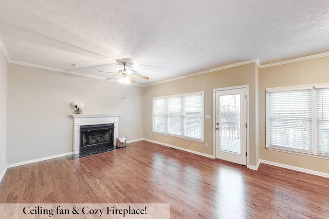 unfurnished living room with crown molding, hardwood / wood-style floors, ceiling fan, and a textured ceiling