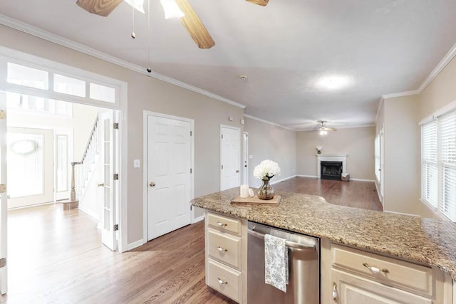 kitchen with light hardwood / wood-style flooring, ceiling fan, dishwasher, light stone counters, and ornamental molding