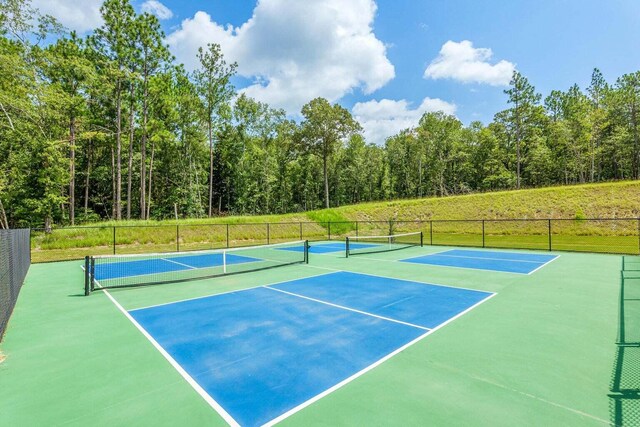 view of tennis court featuring fence