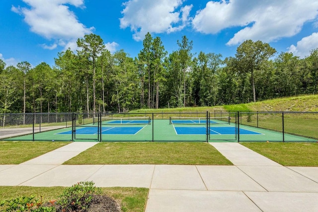 view of basketball court featuring a tennis court, a yard, and fence