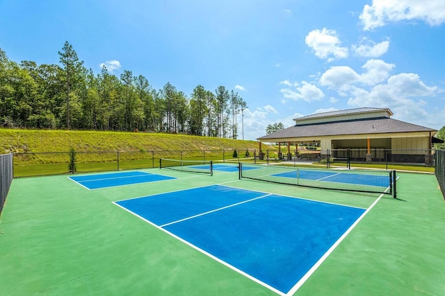 view of tennis court featuring fence