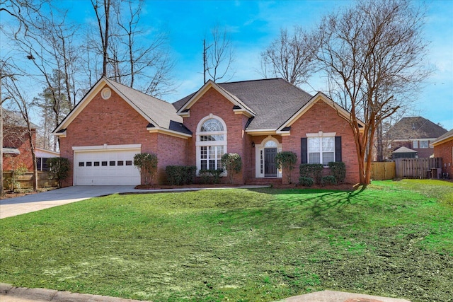 view of front facade featuring concrete driveway, brick siding, a front yard, and fence