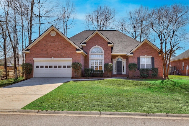 traditional-style house with a garage, concrete driveway, brick siding, and a front yard