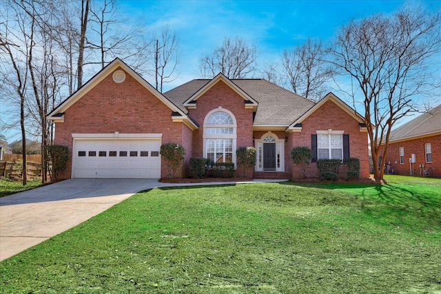 traditional-style home featuring brick siding, roof with shingles, concrete driveway, a front yard, and a garage